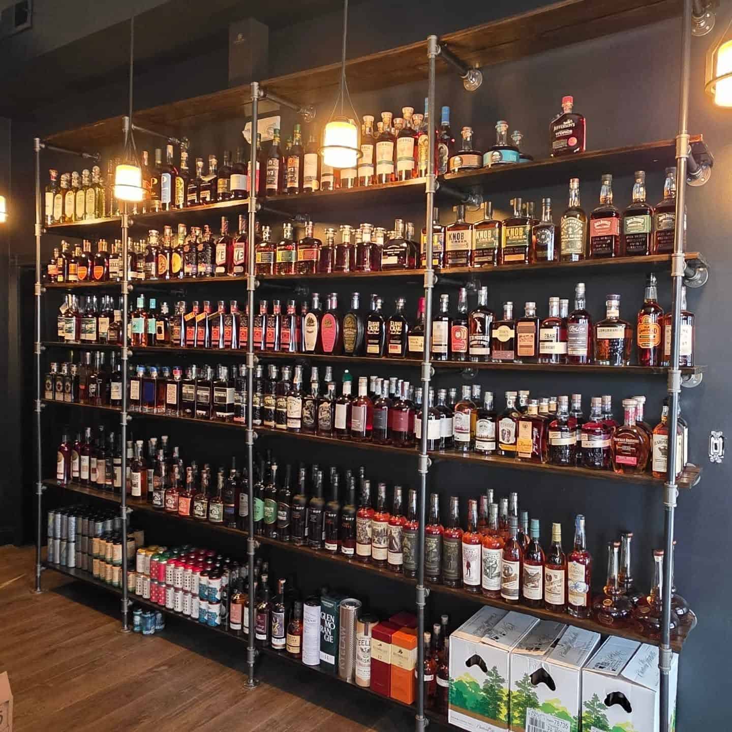Backlit shelves of whiskey bottles in The Sentinel Room whiskey library